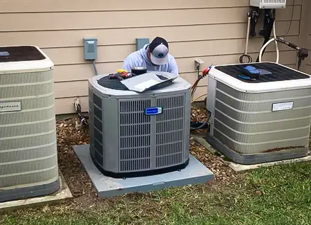 One of our skilled technicians working on a customer's air conditioner.