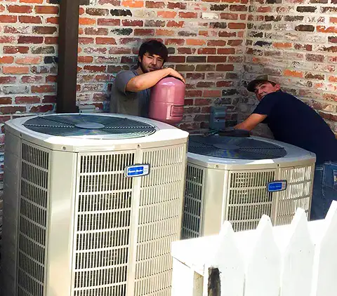 Two Cherokee Services HVAC technicians take a quick break to say hello